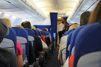 airplane cabin, passengers seated, interior view, air travel experience, airplane seats, flight experience, cabin view, travel photography, airplane interior, passenger seats, air travel
