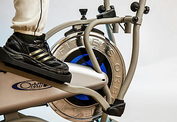 elliptical trainer, fitness equipment, close-up, foot on pedal, workout, exercise machine, fitness footwear, gym equipment, cardio machine, indoor exercise, fitness gear