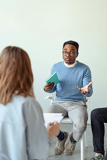 Psykoterapisession, mandlig terapeut, mental sundhed bevidsthed, indendørs terapi, klientengagement, mentalt helbred, terapisession, terapeut, Psykisk sundhedsperson, rådgivning, mental velvære