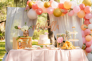 baby shower, dessert table, outdoor garden, cake, balloons, donuts, floral decorations, pink tablecloth, baby shower decorations, garden setting, pastel colors