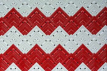 red and white tiles, zigzag pattern, geometric tiles, bold visual design, decorative tiles, red white pattern, red and white decor, zigzag design, bold pattern tiles