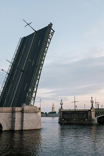 cityscape, drawbridge, Neva River, Saint Petersburg, white nights, dramatic scene, urban landscape, river view, architectural landmark, evening scenery, bridge opening