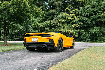 yellow McLaren GT, 2021 McLaren GT, sports car, parked driveway, lush green trees, yellow sports car, McLaren GT, driveway, green trees, rear view, car exterior