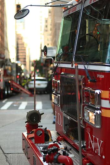 red and white fire truck, New York City, close-up view, day, fire truck, FDNY, urban scene, emergency vehicle, city street, red fire truck, daytime