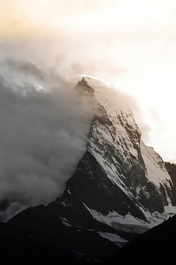 snow-covered mountain, Matterhorn peak, piercing clouds, sunrise, Zermatt, Switzerland, dramatic view, snow-covered Matterhorn, mountain peak, alpine scenery, mountain landscape