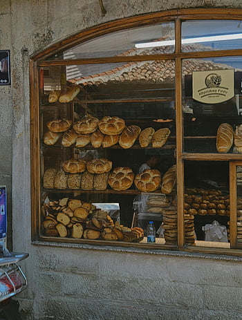 bakery window, freshly baked breads, rustic bakery, inviting display, appetizing breads, variety of breads, Turkish bakery, bakery display, rustic window, appetizing display, freshly baked