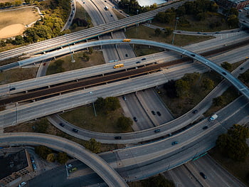 aerial view, urban highway, interchange loop, multi-level highway, busy highway, urban area, intricate view, highway interchange, aerial photography, traffic flow, city infrastructure