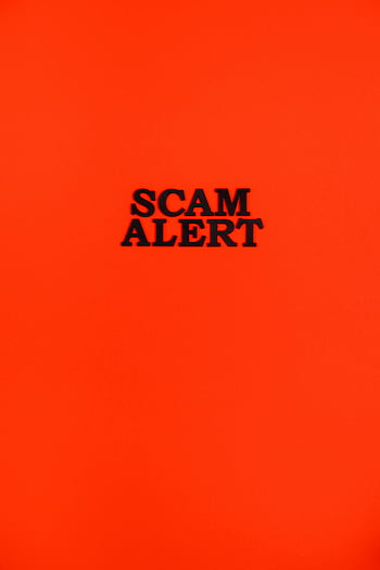 scam alert, black letters, red background, bold message, striking red, caution, awareness, warning sign, fraud warning, security alert, danger signal
