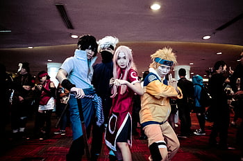 Naruto cosplay, anime costumes, indoor convention, cosplayers, group photo, lively event, character outfits, convention center, cosplay event, anime fans, cosplay group