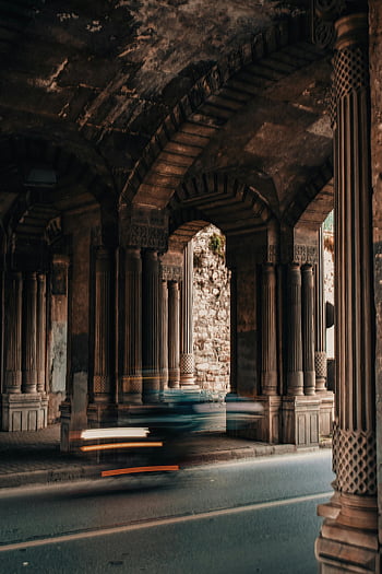 Here are the most relevant photo keywords for SEO based on the provided caption and description:

1. Tunnel with Pillars
2. Captivating Motion Blur
3. Vehicles Passing Through
4. Historic Pillars
5. Istanbul Turkey
6. Architectural Details
7. Long Exposure Photography
8. Travel Photography
9. Cityscape Details

These keywords should help with search engine optimization for the photo.