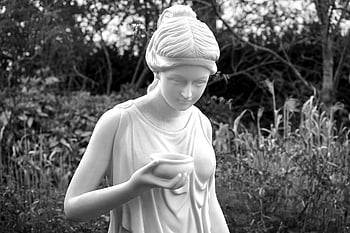 woman holding bowl statue, classical statue, black and white photo, serene photo, lush park, art lovers, outdoor sculpture, garden art, marble statue, female statue, nature backdrop