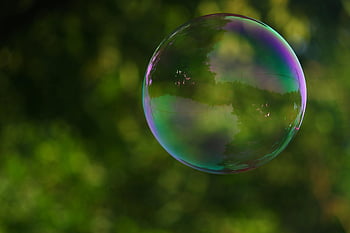 bubble photography, colorful soap bubble, nature reflection, park setting, blurred green background, focus photography, outdoor bubble, natural colors, vibrant bubble, soap bubble art