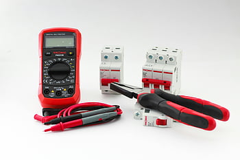 digital multimeter, electrical tools, circuit breakers, pliers, white background, close-up, electrical devices, multimeter probes, electrical equipment, safety tools, electrical components