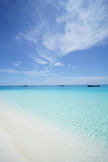 boats on sea, peaceful beach, crystal clear waters, deep blue sky, travel inspiration, tropical beach, serene beach, beach scene, clear water, blue sky, vacation destination