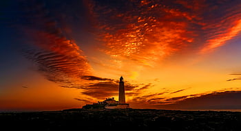 lighthouse silhouette, St Mary's Lighthouse, vibrant sunset, sunset sky, lighthouse at sunset, coastal sunset, lighthouse photography, sunset photography, lighthouse scene, sunset lighthouse, lighthouse landscape