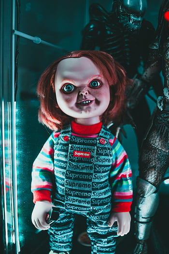 spooky doll, red-haired doll, overalls, eerie lighting, horror themes, indoor setting, creepy doll, scary doll, horror doll, indoor horror, eerie atmosphere