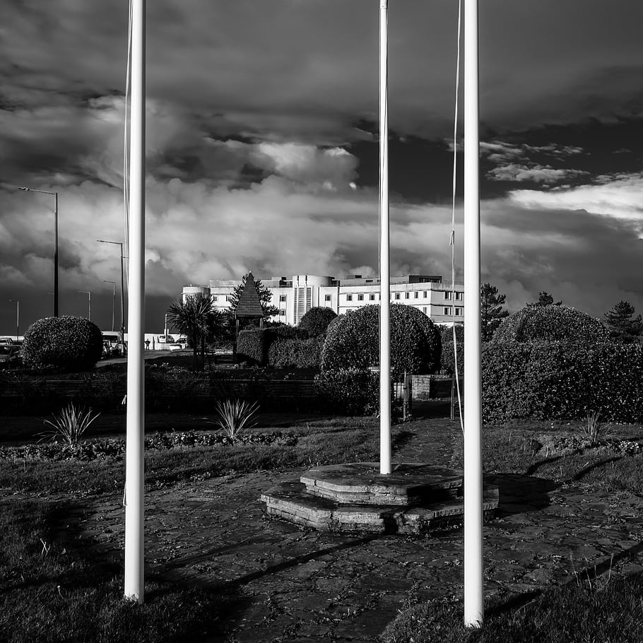 black and white, Morecambe, Lancashire, seaside, coast, England, UK, flag poles, early morning, cloudy sky, building