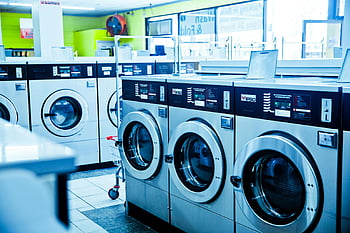 gray front load washing machines, contemporary laundromat, industrial washing machines, public use, row of washing machines, laundromat interior, front load washers, public laundry, laundry equipment, laundry room, self-service laundry