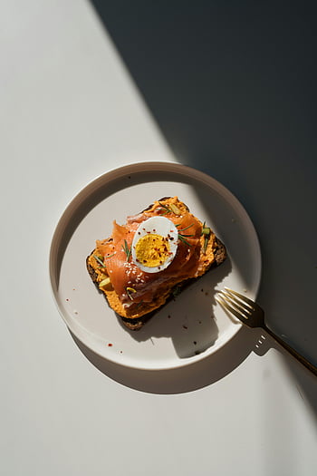 bread with hummus, smoked salmon, boiled egg, spices, natural light, stylish plate, hummus toast, smoked salmon toast, egg toast, healthy breakfast, food photography