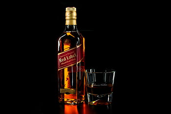 Johnnie Walker Red Label, whiskey bottle, drinking glass, shallow focus, amber color, glossy reflection, dark background, close-up, alcohol, spirits, liquor