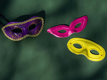 purple carnival mask, pink carnival mask, yellow carnival mask, Venetian masks, colorful masks, masquerade masks, green surface, carnival accessories, festive masks, party masks, decorative masks