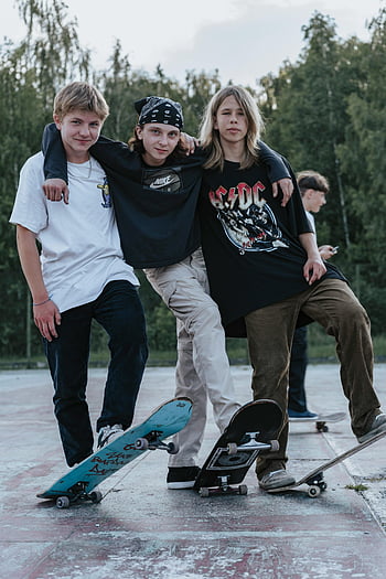 skateboards, teenage skateboarders, outdoor park, friendship, posing together, three boys, skateboarding, casual clothing, summer day, skate park, trees background
