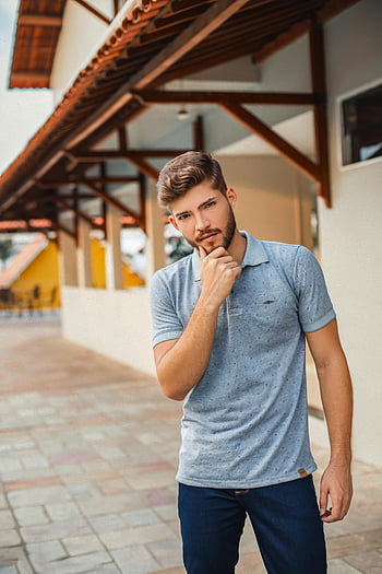 man in gray polo shirt, stylish man, beard, casual outfit, urban background, pensively outdoors, building, gray polo shirt, casual fashion, urban style, outdoor portrait