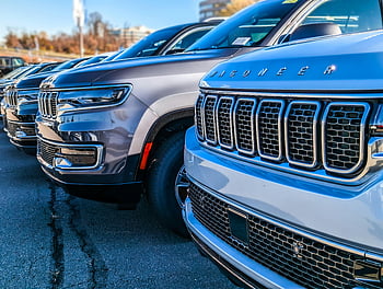 Jeep Wagoneer, modern SUVs, car dealership, parking lot, close-up view, new vehicles, dealership lot, luxury cars, automotive sales, vehicle lineup, car sales