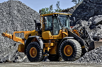 construction loader, yellow loader, industrial quarry, gravel moving, powerful machinery, quarry site, rock piles, heavy equipment, mining industry, earthmoving equipment, construction site