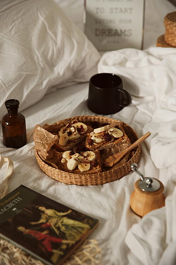 breakfast tray, banana toast, cozy bed, woven plate, warm breakfast, bed setting, morning meal, breakfast in bed, cozy breakfast, banana slices, breakfast spread