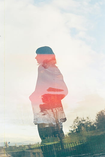 film photo, silhouette woman, double exposure, dreamy vibe, nostalgic feel, creative photography, outdoor scene, artistic effect, vintage aesthetic, soft lighting, layered image