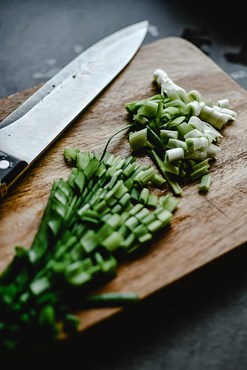sliced onion leeks, wooden chopping board, chopped scallions, culinary content, close-up, knife, cooking ingredients, food photography, green onions, kitchen tools, healthy eating