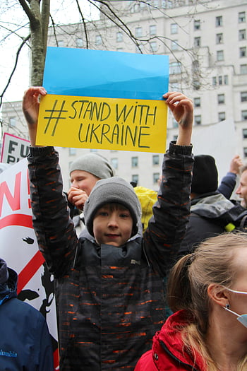 Vancouver rally, boy, Stand with Ukraine, Ukraine solidarity, war protest, young protestor, anti-war rally, Vancouver protest, Ukrainian support, public demonstration, peace rally