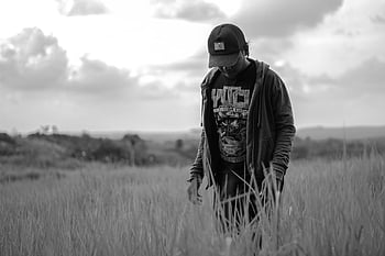 black and white, man, grass field, rural, walking, outdoor, monochrome, nature, landscape, countryside, cap