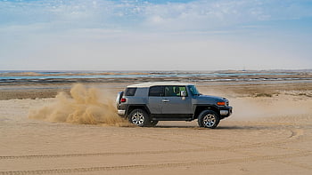 SUV, drifting, sandy beach, sunlight, rugged SUV, desert sands, off-road adventure, thrill, sandy terrain, beach driving, desert exploration