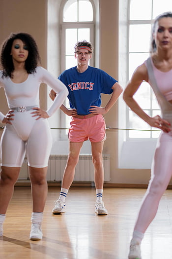 fitness instructor, group exercise class, diverse participants, bright indoor gym, energetic workout, dance class, exercise attire, fitness class, dance studio, workout group, fitness participants