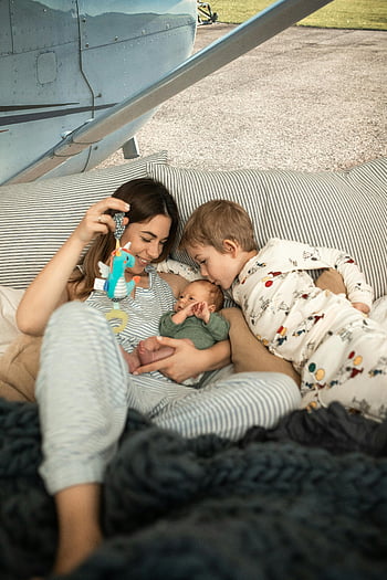 happy family, mother, baby, son, relaxing moment, outdoors, airplane, family photo, outdoor family, airplane background, family bonding