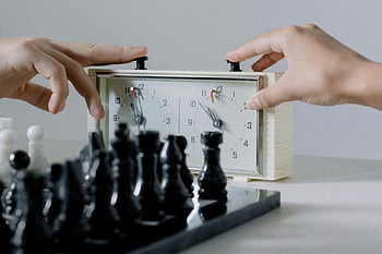 chess clock, hands pressing, chessboard, intense game, close-up, chess pieces, board game, chess timer, game session, chess players, chess strategy
