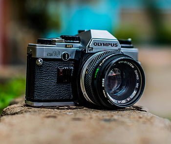 Olympus OM10, vintage camera, classic camera, film camera, analogue camera, close-up photo, vintage photographic equipment, OM-System Zuiko, retro camera, camera lens, close-up shot