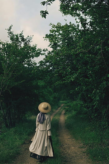 woman in hat, green park, forest path, calm atmosphere, serene environment, stylish female, walking outdoors, nature scene, coat and hat, greenery, strolling woman