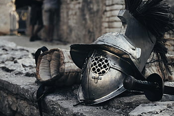 Silver Knight Helmet, medieval armor, sword, glove, stone wall, historical combat gear, medieval helmet, combat equipment, knight gear, medieval weapon, stone background