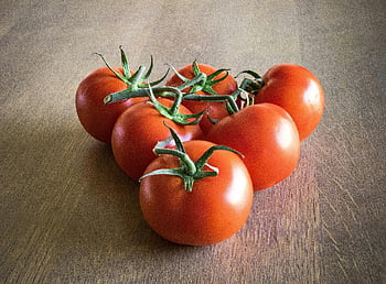 ripe red tomatoes, wooden table, vibrant color, freshness, orange tomatoes, triangle formation, brown surface, fresh produce, healthy food, natural ingredients, vegetable photography