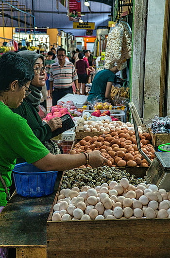 market scene, vegetable stall, diverse selection, eggs, Banten, Indonesia, vibrant market, people standing, market stall, quail eggs, chicken eggs