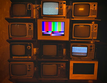 vintage televisions, static screens, color test patterns, retro TVs, stacked televisions, old televisions, analog TVs, television collection, vintage electronics, classic TVs, antique televisions