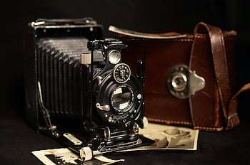 antique Voigtlander camera, black classic camera, brown leather bag, vintage photography equipment, close-up camera, leather case, vintage camera, antique camera, photography equipment, close-up shot, vintage Voigtlander