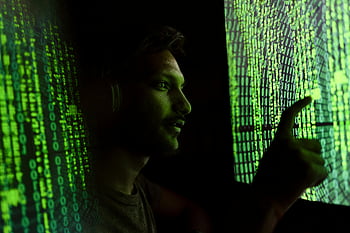 man between screens, digital code, cybersecurity technology, screen interaction, digital security, person interacting, digital screens, tech security, screen code, digital interface, human-computer interaction
