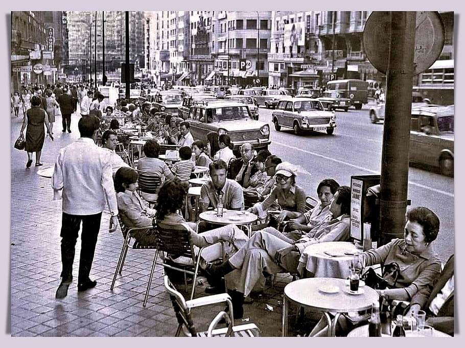 Madrid, Spain, Gran Via, 1970s, cafe terrace, outdoor seating, people, cars, street scene, black and white, colorized