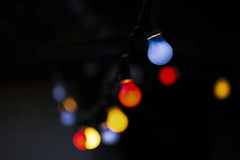 turned-on LED bulbs, vivid string lights, festive atmosphere, moody atmosphere, colorful lights, bokeh effect, night lighting, outdoor decoration, holiday lights, string lights, LED string lights