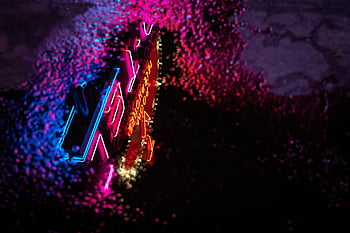 neon light reflection, colorful neon sign, puddle reflection, dark rainy night, city street, vibrant modern style, neon sign, puddle, rainy night, neon reflection