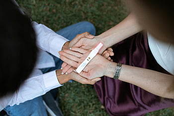pregnancy test, positive result, couple, anticipation, joy, outdoors, pregnancy kit, shared moment, future parents, emotional moment, grass background
